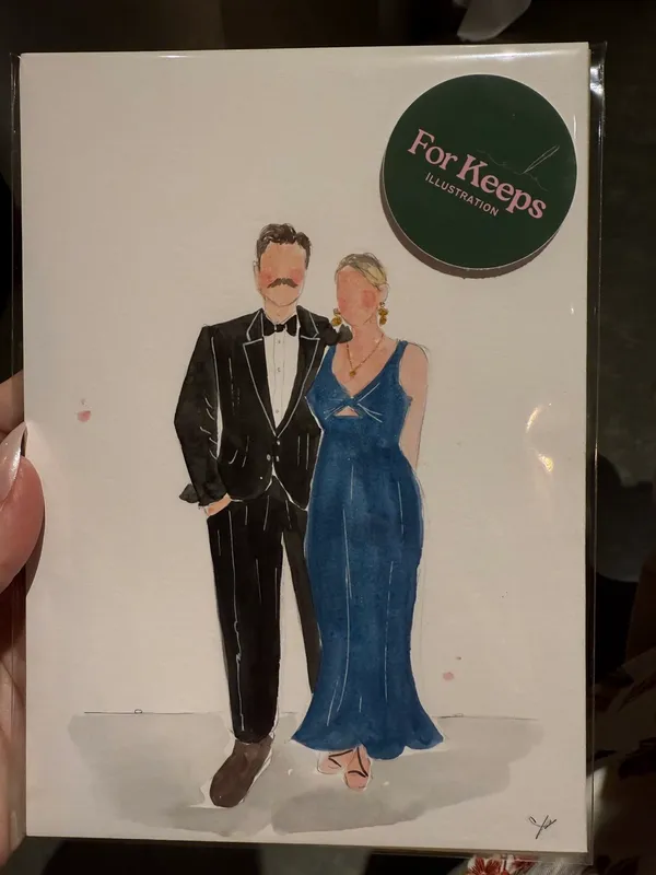 Live watercolour guest portrait of a couple in a tuxedo and blue gown, painted at a wedding by Kirsty Wyatt
