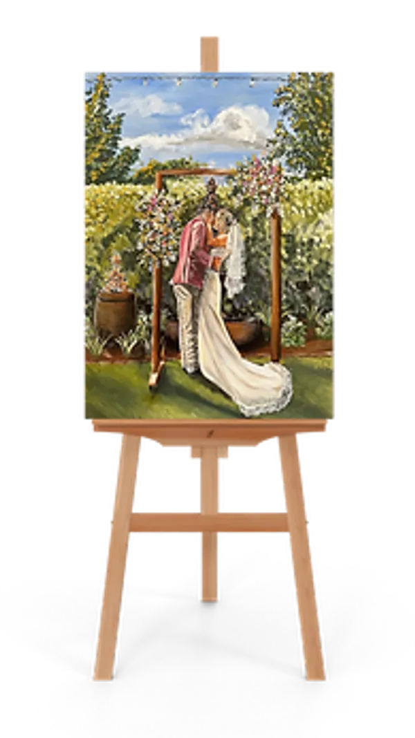 Acrylic wedding painting on an easel of a couple kissing under a floral arbour in a vineyard, by Art By Grace