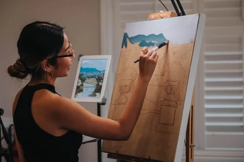 Joselle Reyes sketching an oil wedding landscape with stone urns and blue mountains onto canvas, by Joselle Reyes