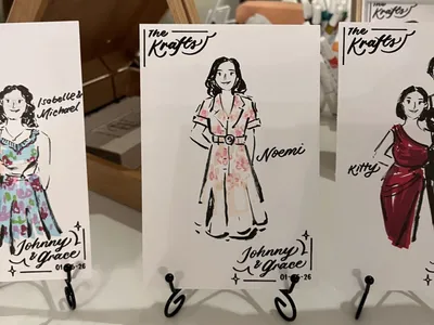Ink and marker live guest sketches of women in floral and red dresses on personalised wedding cards, by Let Me Draw You