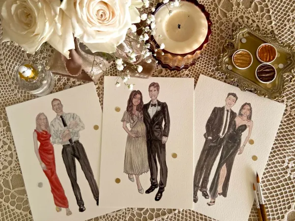 Watercolour fashion portraits of three wedding guest couples beside brushes and gold paints by Lisa's Tiny Studio