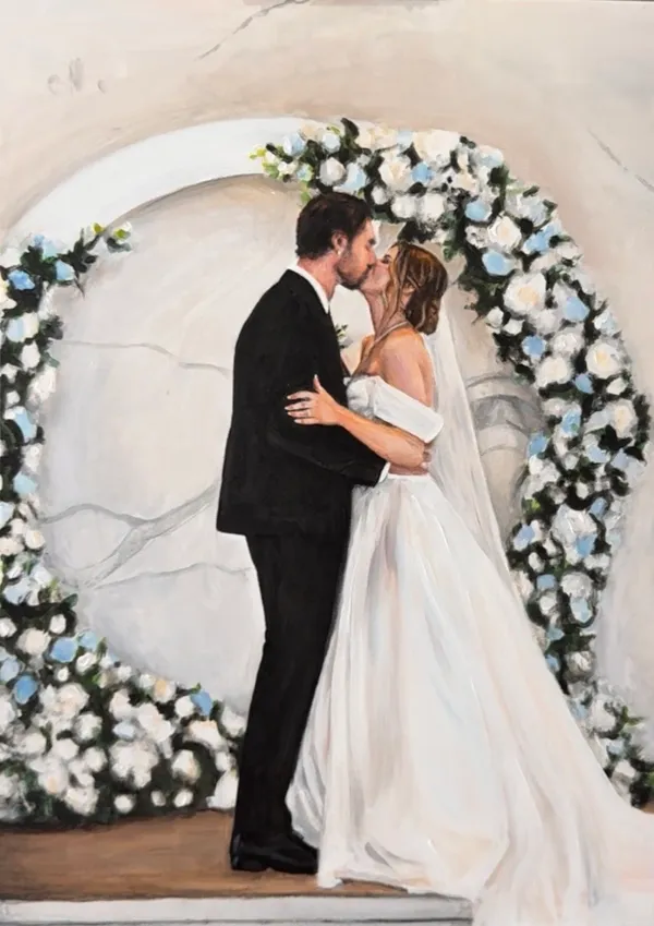 Painting of a bride and groom kissing in front of a white and blue floral arch, by Tamlyn Jade Art
