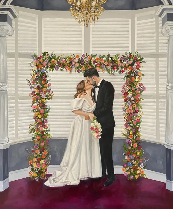 Live acrylic and oil wedding painting of a couple kissing under a colourful floral arch by Your Wish I Paint
